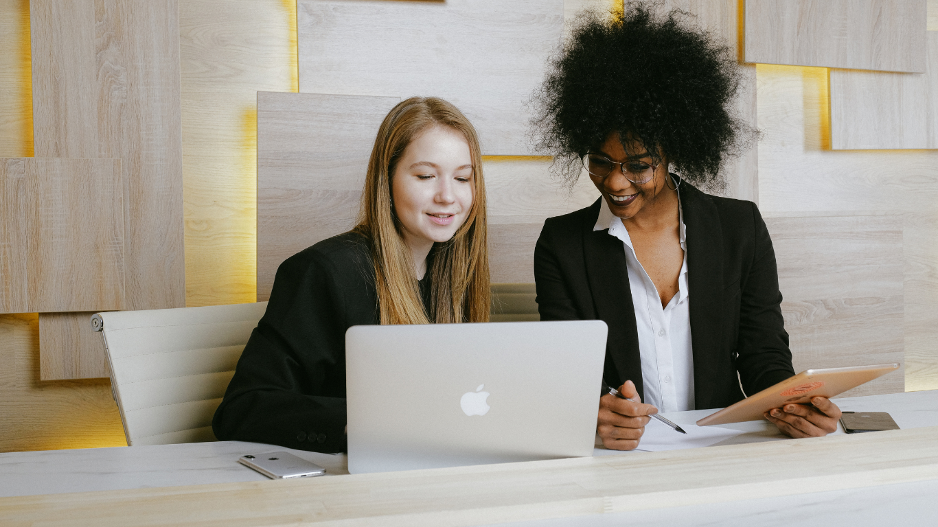 two young women looking at laptop screen